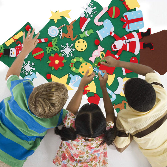 Three kids decorating a felt Christmas tree on the floor