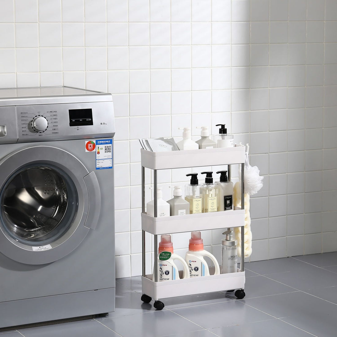 Slim rolling storage cart shown between appliances