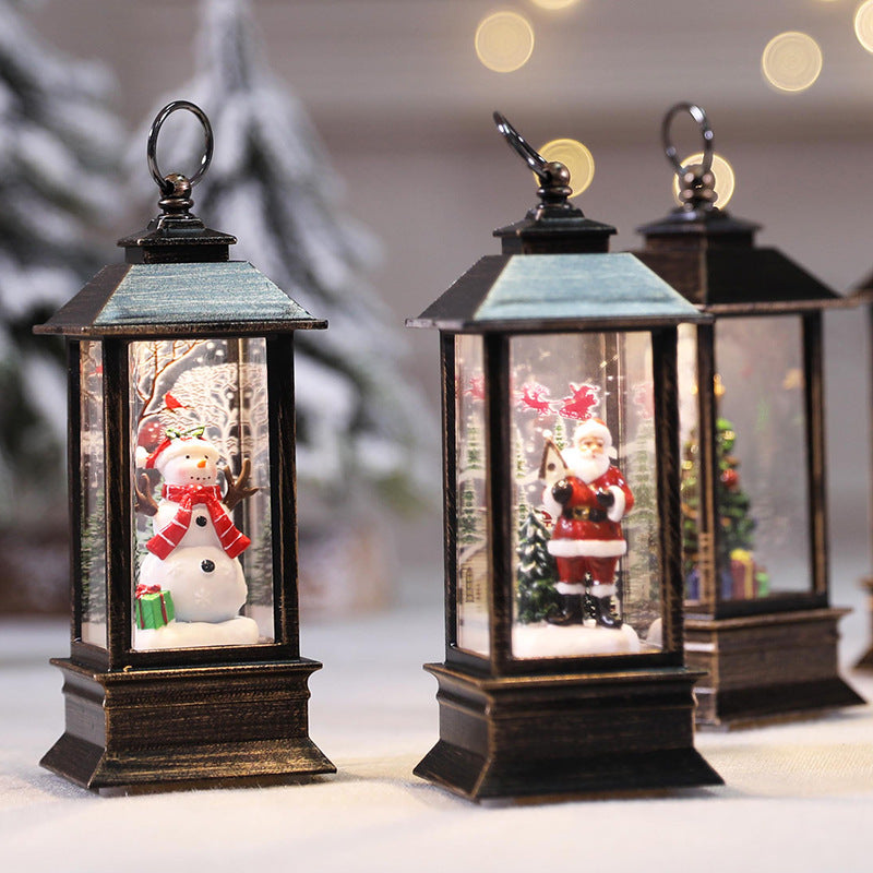 Snowman, Santa and tree Christmas LED lanterns on a table