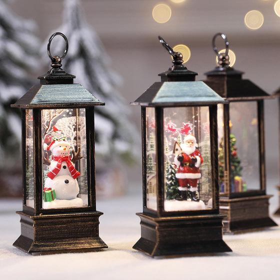 Snowman, Santa and tree Christmas LED lanterns on a table