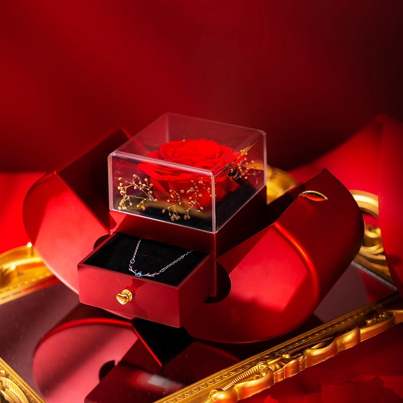 Red apple rose box open with silver necklace in the drawer, gold accent scene