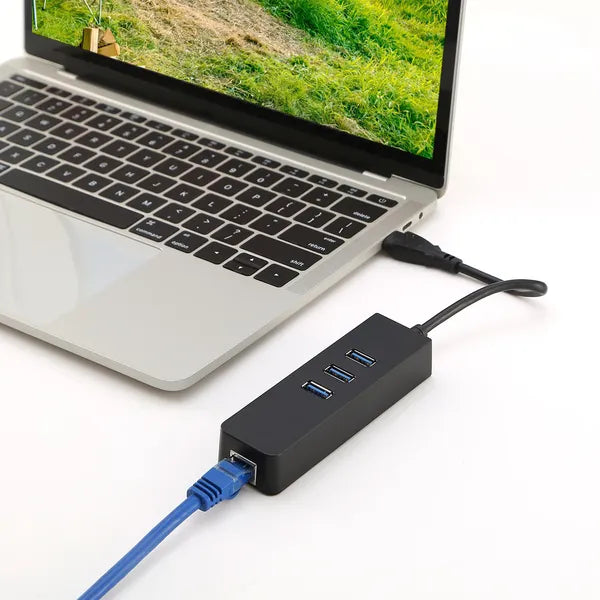 USB hub with Ethernet cable connected to a laptop on a desk