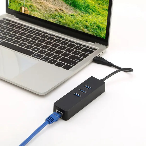USB hub with Ethernet cable connected to a laptop on a desk