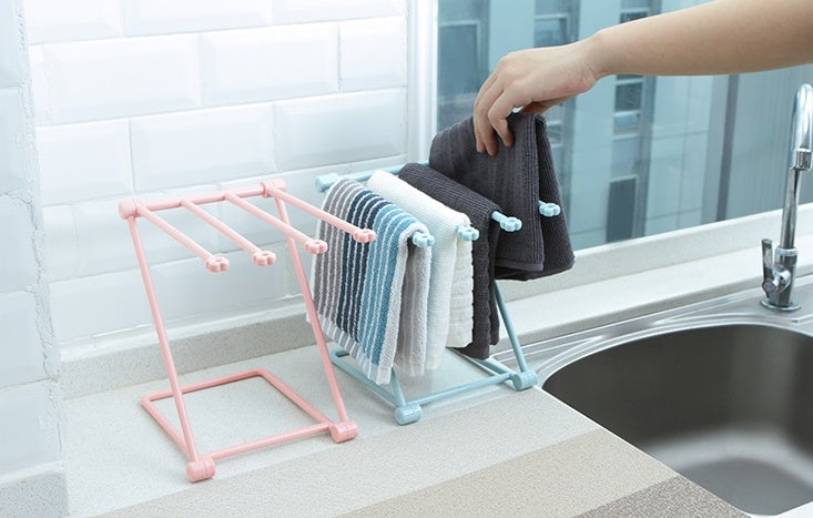 Kitchen organizer rack holding dishcloths and sponge