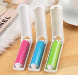 Lint roller and dust brush on upholstery