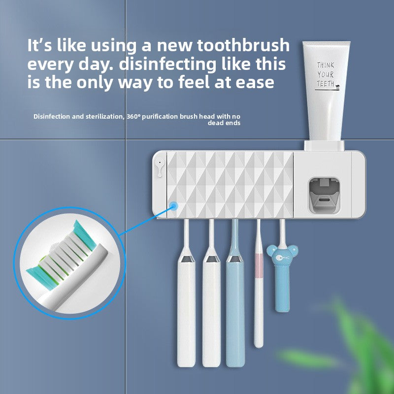White wall-mounted toothbrush rack with toothpaste dispenser and toothbrushes