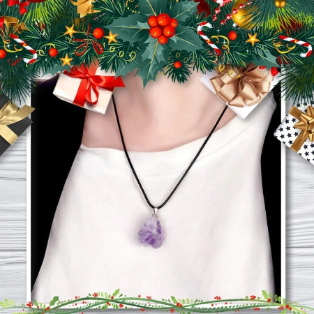 Purple raw crystal pendant on a black cord worn over a white top