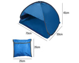 Pop-up beach tent open on sand