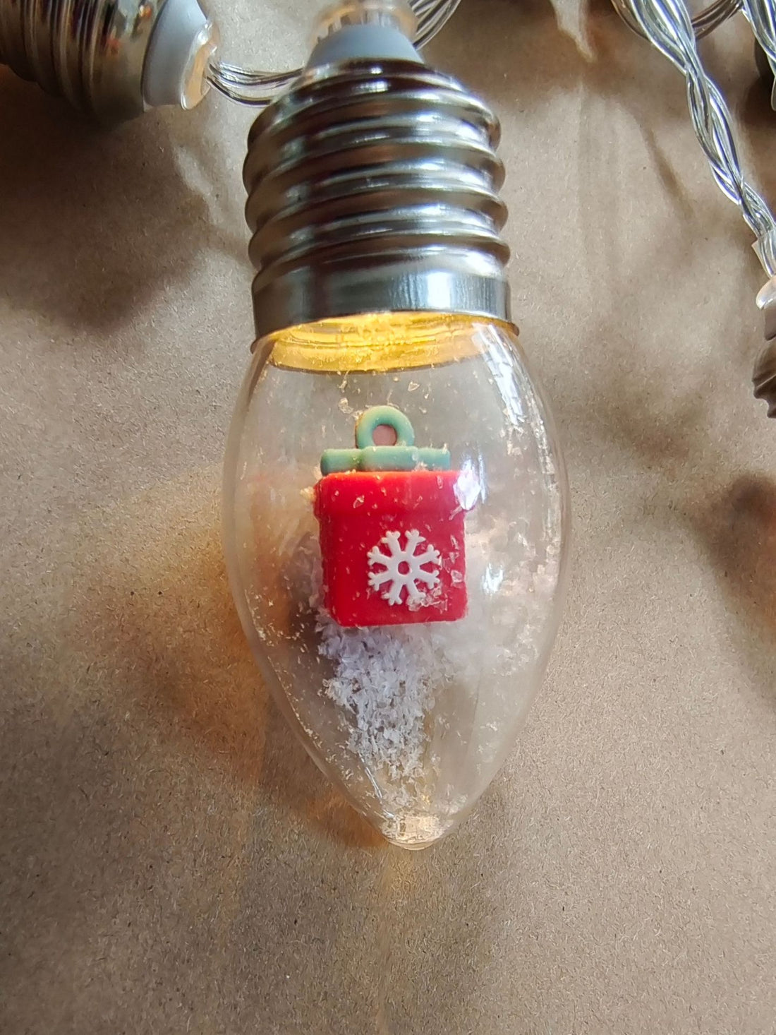 Clear bulb string light with a miniature red gift box inside, Gift Box option
