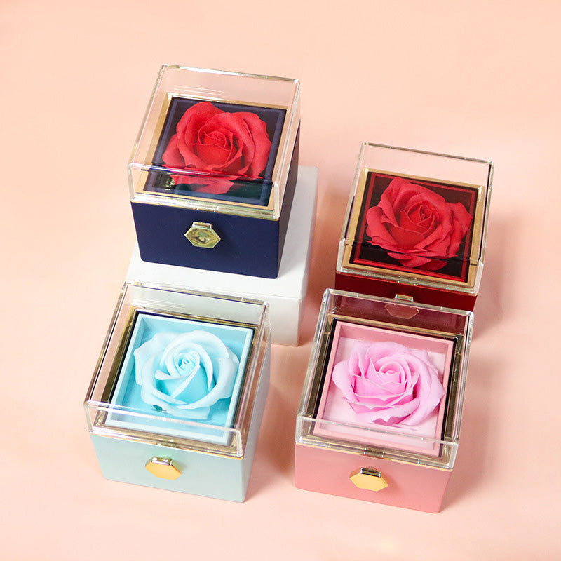 Blue and pink rotating rose jewelry boxes with soap roses on a white base