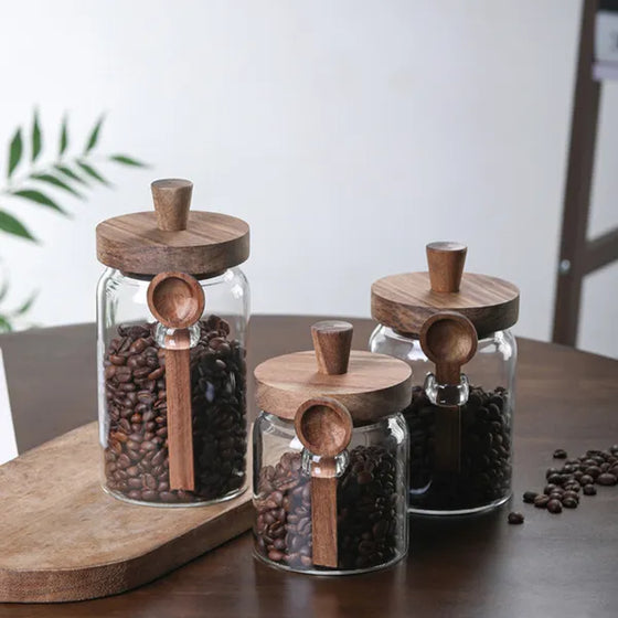 Three glass coffee jars on a wooden board