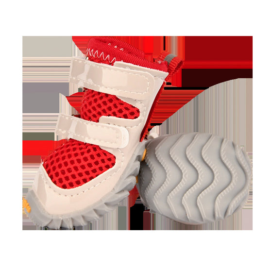 Red mesh dog shoe with a wavy gray sole