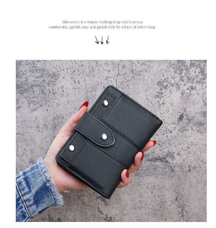 Hand holding the black slim wallet