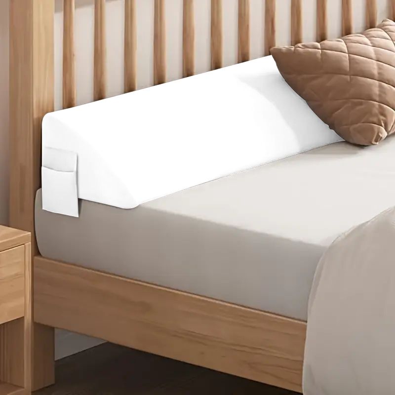 White gap filler pillow on a wooden bed with a side pocket