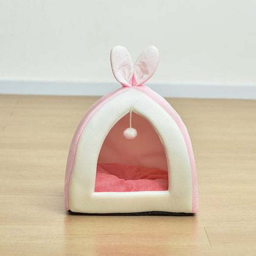 Cat peeking out from inside the bunny house