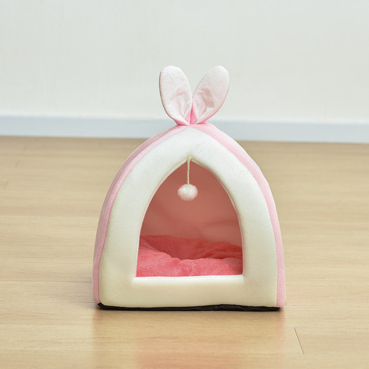 Cat peeking out from inside the bunny house