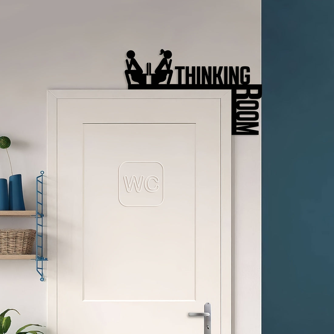Black Thinking Room door topper sign on a bathroom door frame
