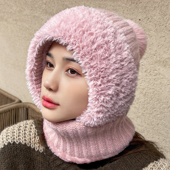 Woman wearing a pink knit hood with plush trim