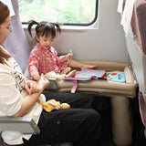 Portable inflatable travel bed for kids on a train seat napping setup