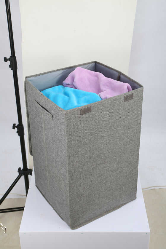 Grey laundry hamper full of clothes