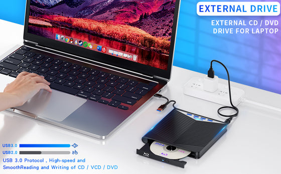 External DVD drive connected to a laptop on a desk