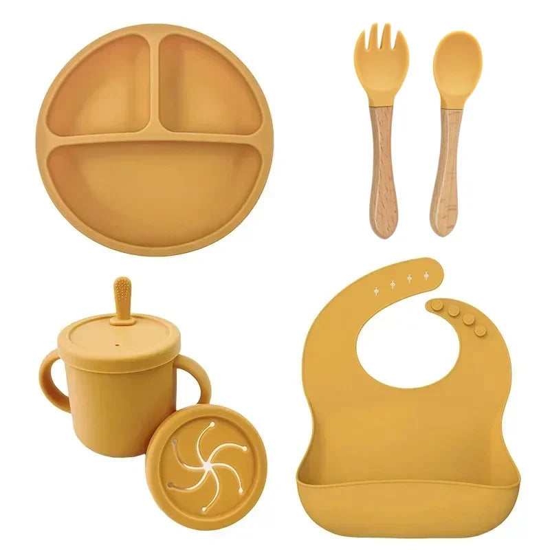 Silicone baby feeding set in use by toddler