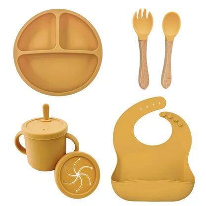 Silicone baby feeding set in use by toddler