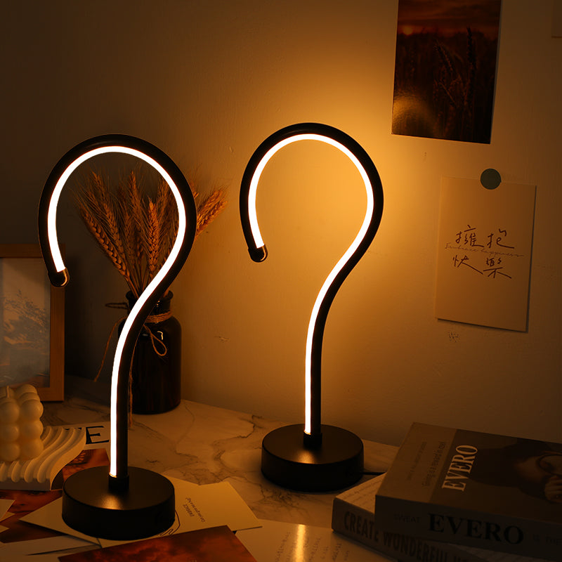 Two question mark lamps glowing warm and cool white