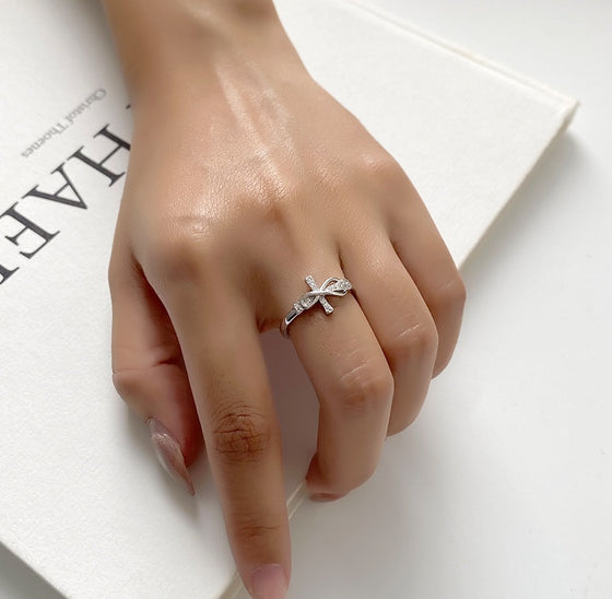 Hand wearing the rhinestone bow ring
