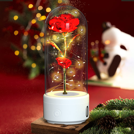 Red rose LED lamp in a glass dome on a white Bluetooth speaker base