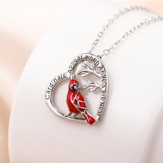 Cardinal heart pendant displayed on a white bust