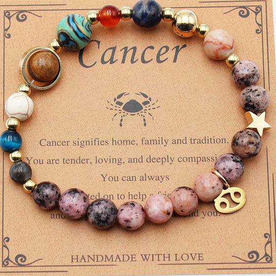 Cancer zodiac bracelet with pink beads on its card