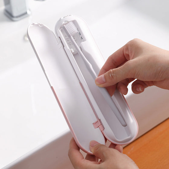 Slim white toothbrush case opened to show a toothbrush inside