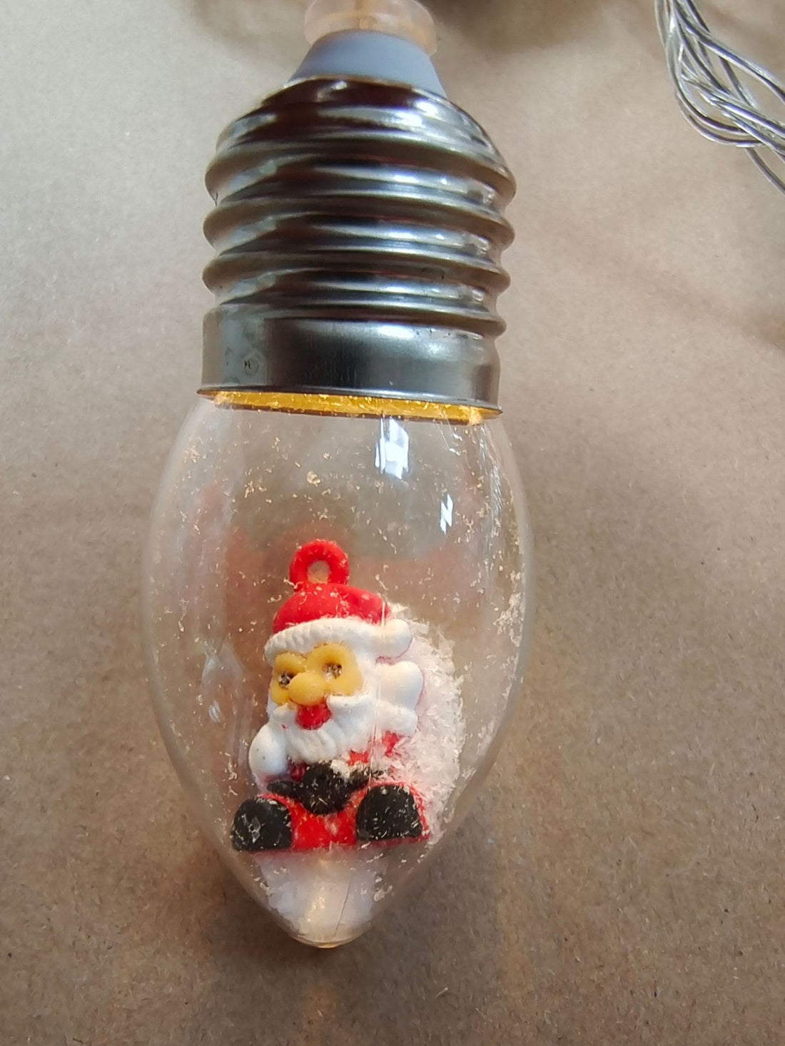 Clear bulb string light with a miniature Santa Claus figure inside