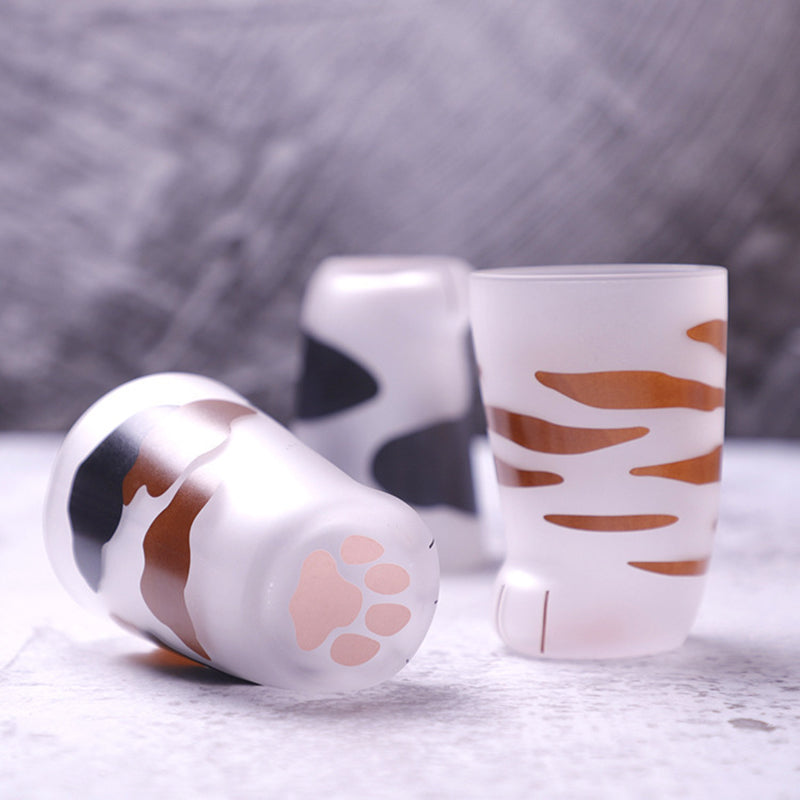 Cat paw glass mugs lying on their side showing the paw pad base