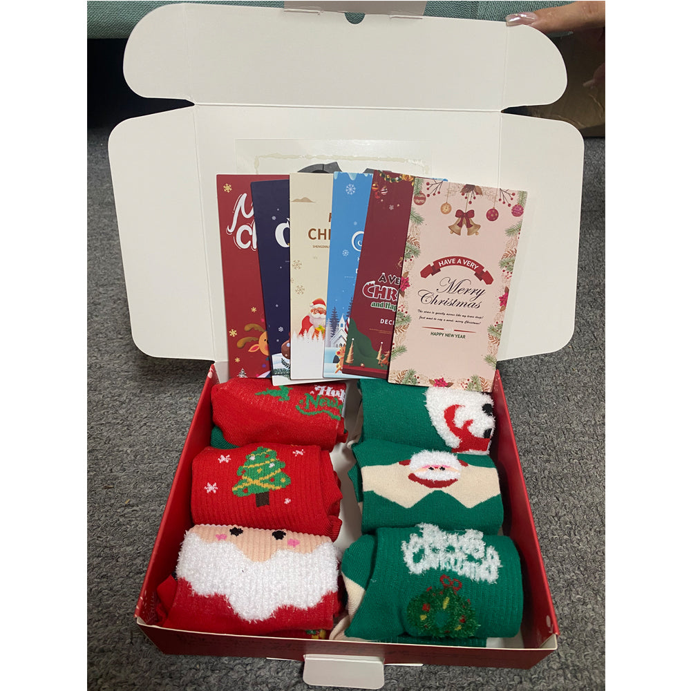 Christmas socks gift box opened to show six pairs of socks and greeting cards