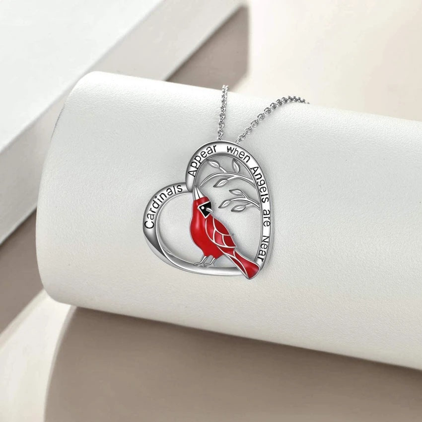 Rhinestone heart cardinal pendant displayed on a bust