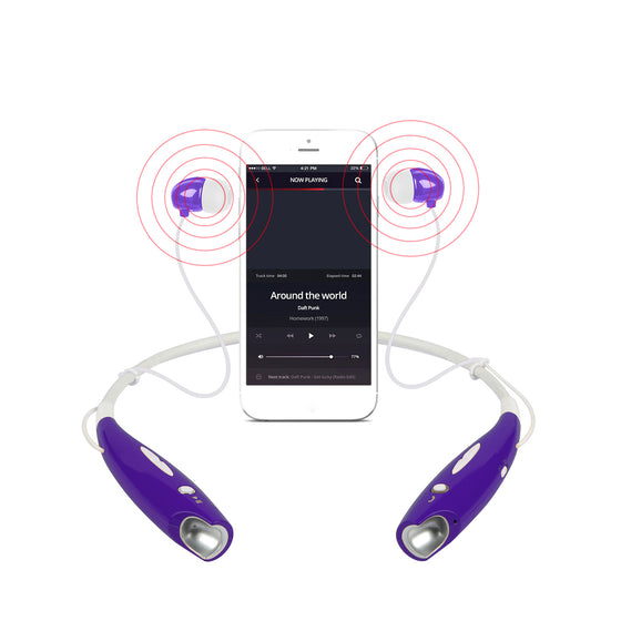Purple neckband headphones next to a phone playing music