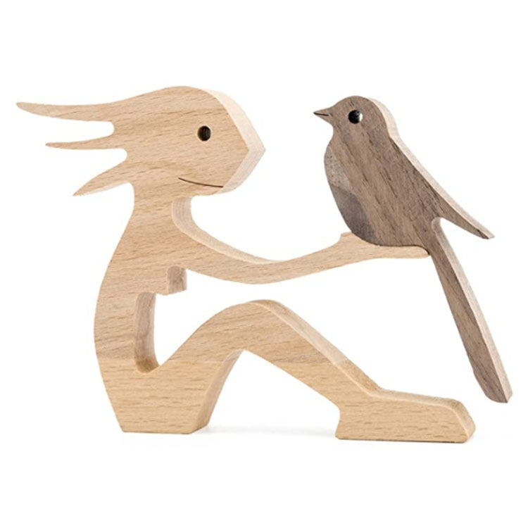 Wood carving of a seated woman with a bird on her hand, light wood