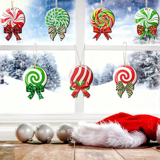 Peppermint candy and lollipop Christmas ornaments hanging in a window