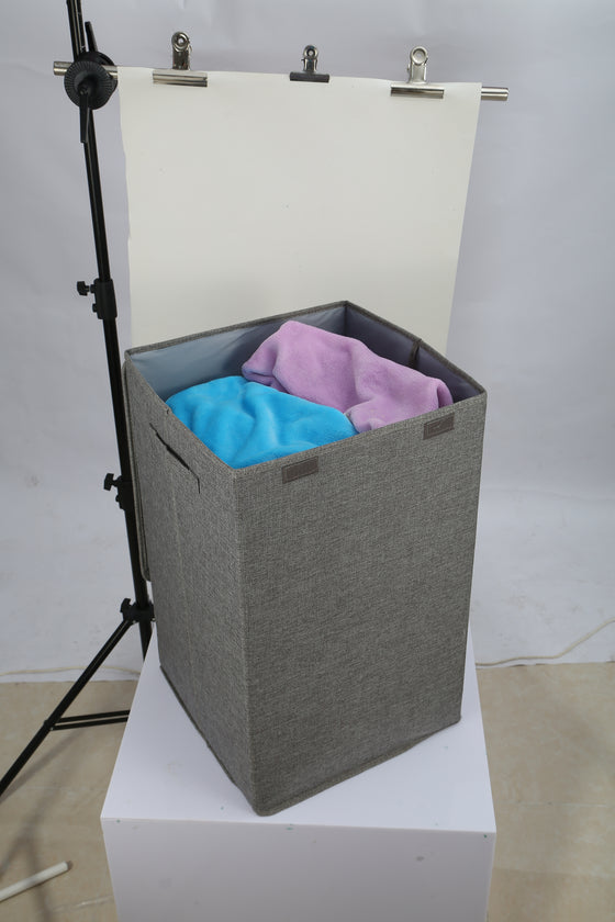 Grey laundry hamper with clothes and lid open