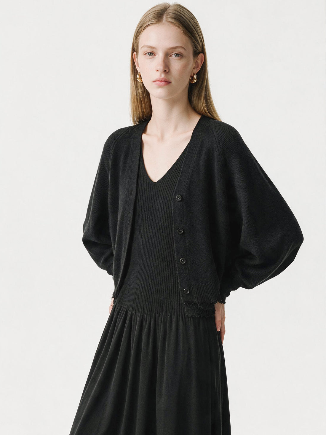 Black ribbed knit V-neck dress with flutter sleeves and pleated skirt, photo 1