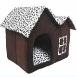 Barn-shaped pet house shown fully open with gable roof