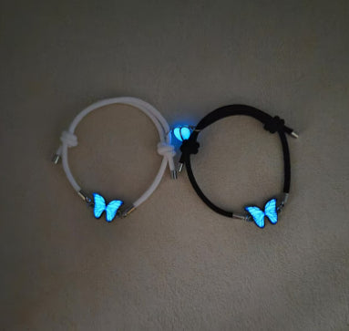 Black and white cord bracelets with glowing butterflies, the included pair