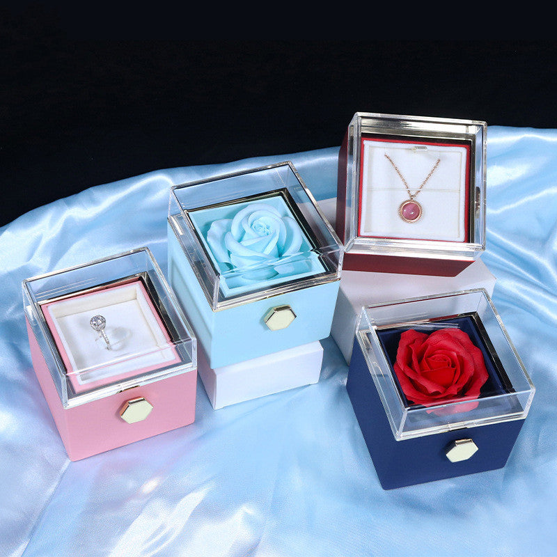 Blue, pink and white rotating rose jewelry boxes with necklaces inside