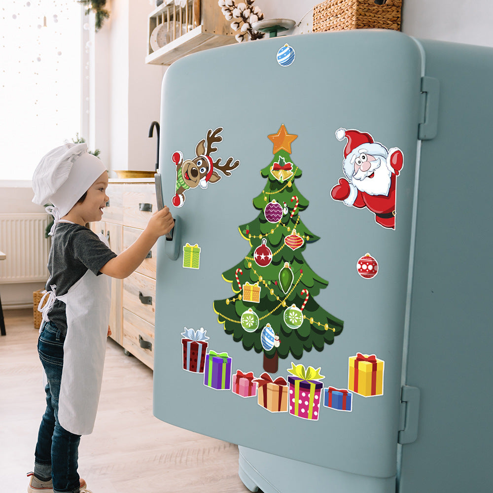Child applying Christmas tree decals to a refrigerator door