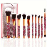10-piece makeup brush set with pink glitter crystal handles beside a rose gold travel pouch