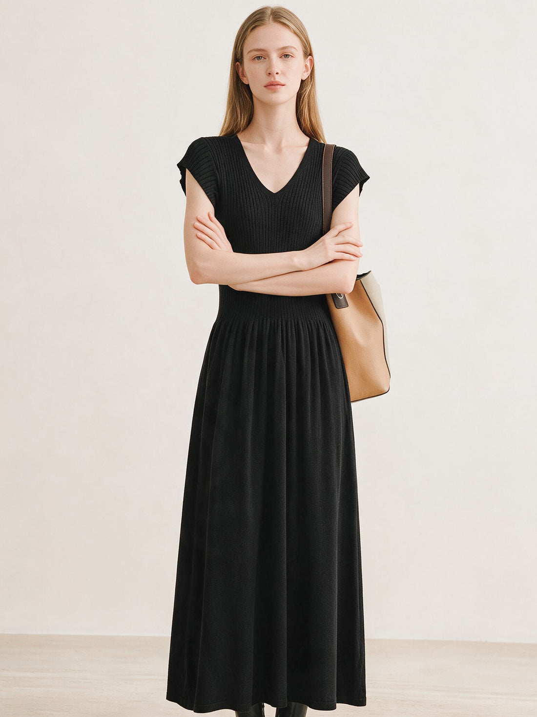 Black ribbed knit V-neck dress with flutter sleeves and pleated skirt, photo 3