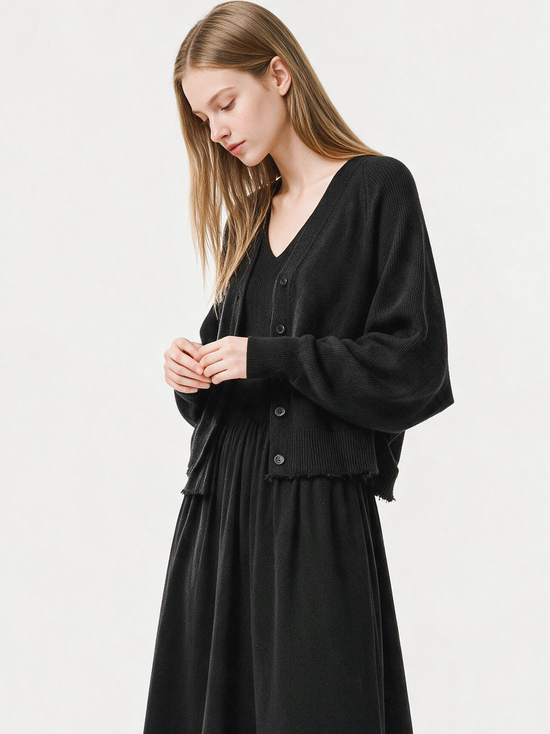 Black ribbed knit V-neck dress with flutter sleeves and pleated skirt, photo 5