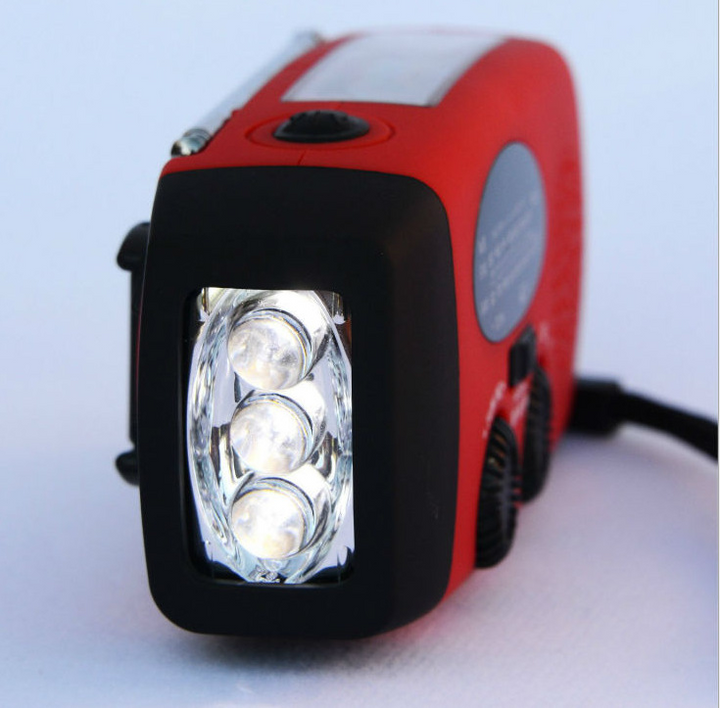 Radio flashlight hand crank in use